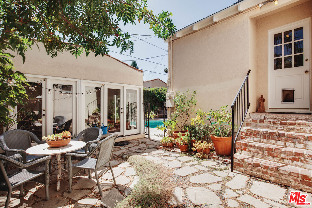 9018 Elevado Avenue West Hollywood, CA 90069 - Photo 24 of 32 a view of a patio with table and chairs and potted plants