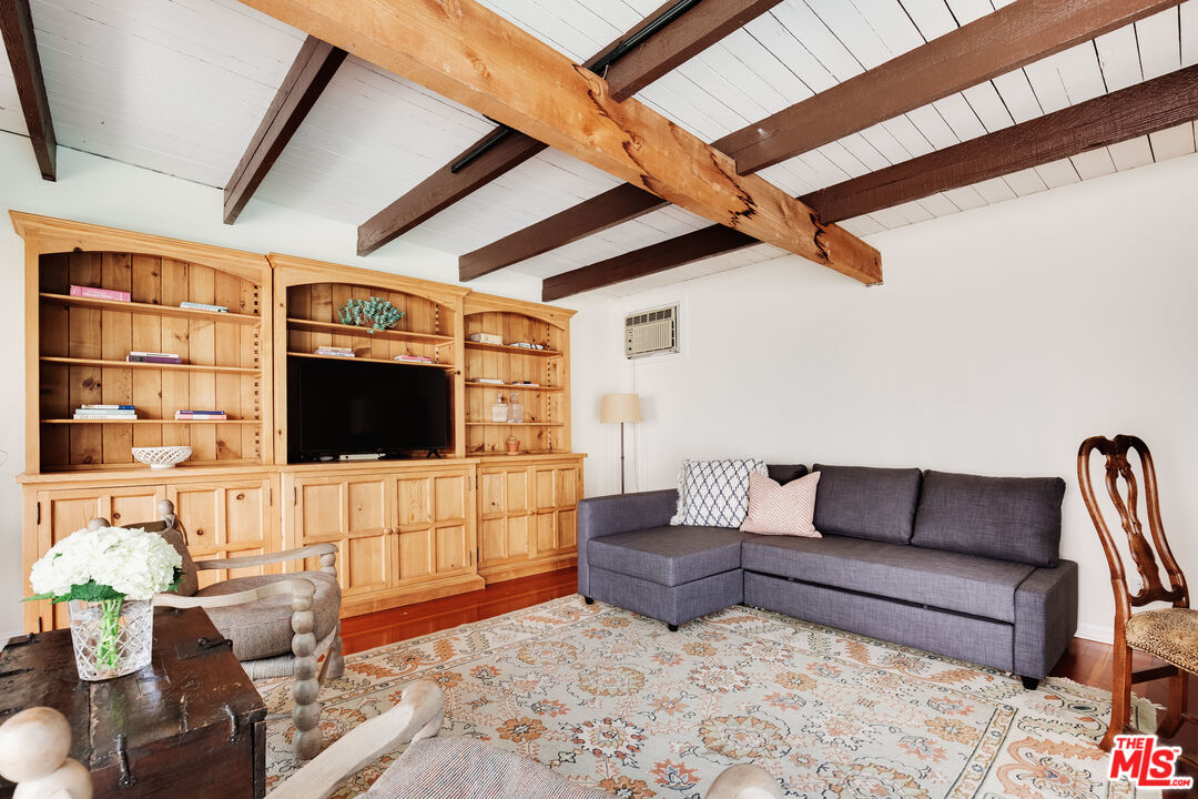 9018 Elevado Avenue West Hollywood, CA 90069 - Photo 29 of 32 a living room with furniture and a flat screen tv
