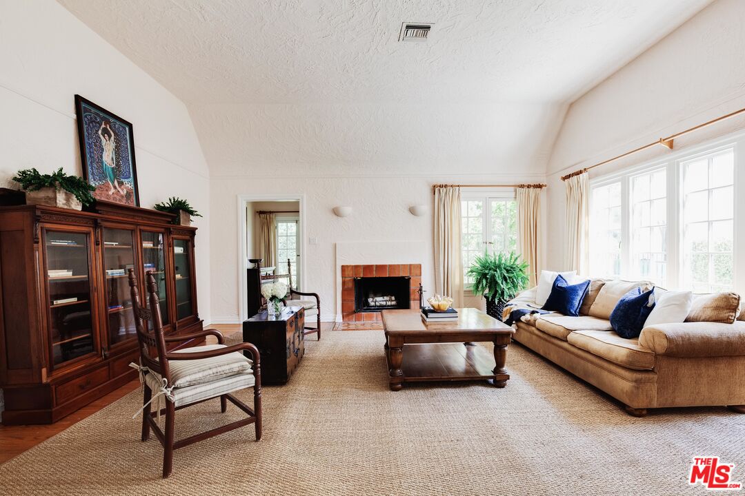 9018 Elevado Avenue West Hollywood, CA 90069 - Photo 8 of 32 a living room with furniture and a fireplace