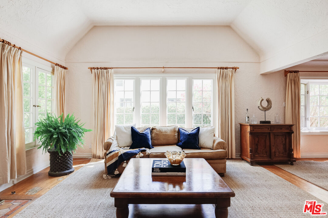 9018 Elevado Avenue West Hollywood, CA 90069 - Photo 9 of 32 a living room with furniture and large windows