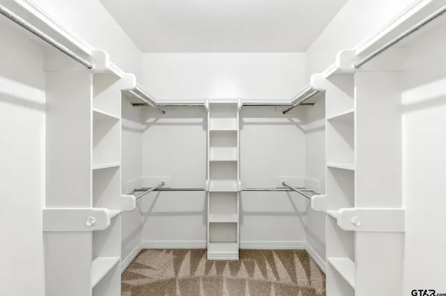 a view of an empty room with a ceiling fan