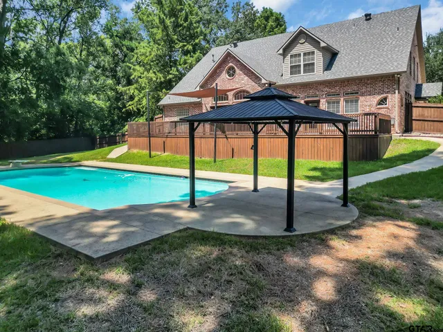 an empty room with fireplace cabinet and windows
