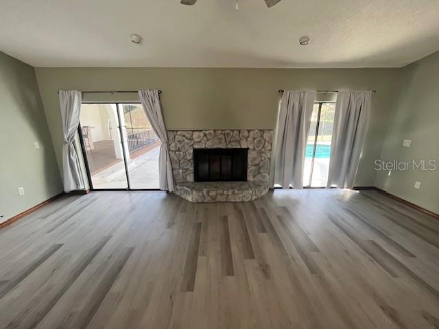 5375 Patricia Place Weeki Wachee, FL 34607 - Photo 16 of 61 an empty room with wooden floor fireplace and windows