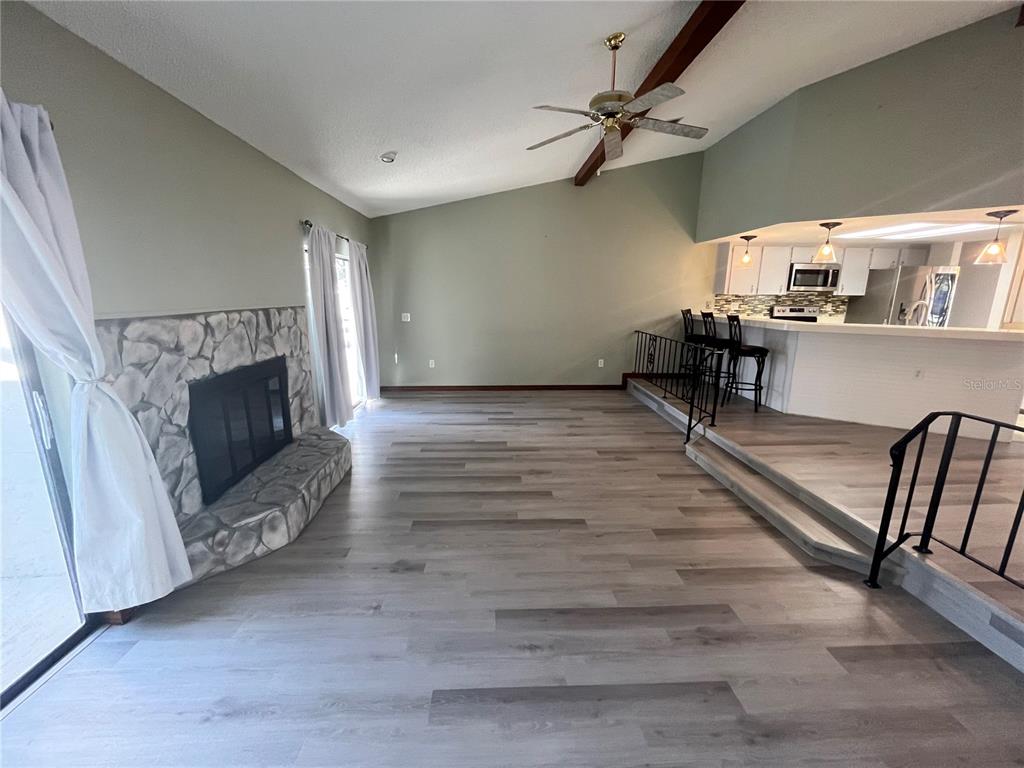 5375 Patricia Place Weeki Wachee, FL 34607 - Photo 17 of 61 a living room with furniture and a fireplace