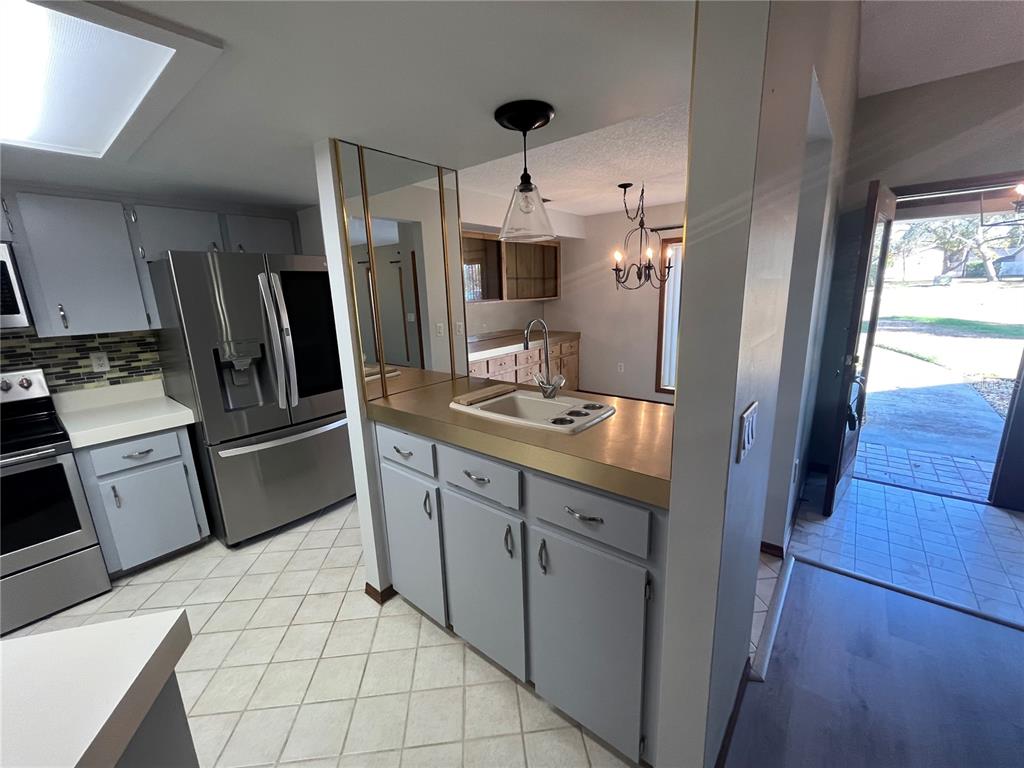 5375 Patricia Place Weeki Wachee, FL 34607 - Photo 24 of 61 a kitchen with stainless steel appliances a refrigerator sink and microwave