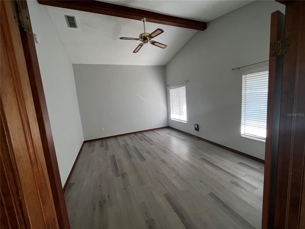 5375 Patricia Place Weeki Wachee, FL 34607 - Photo 26 of 61 an empty room with wooden floor and windows