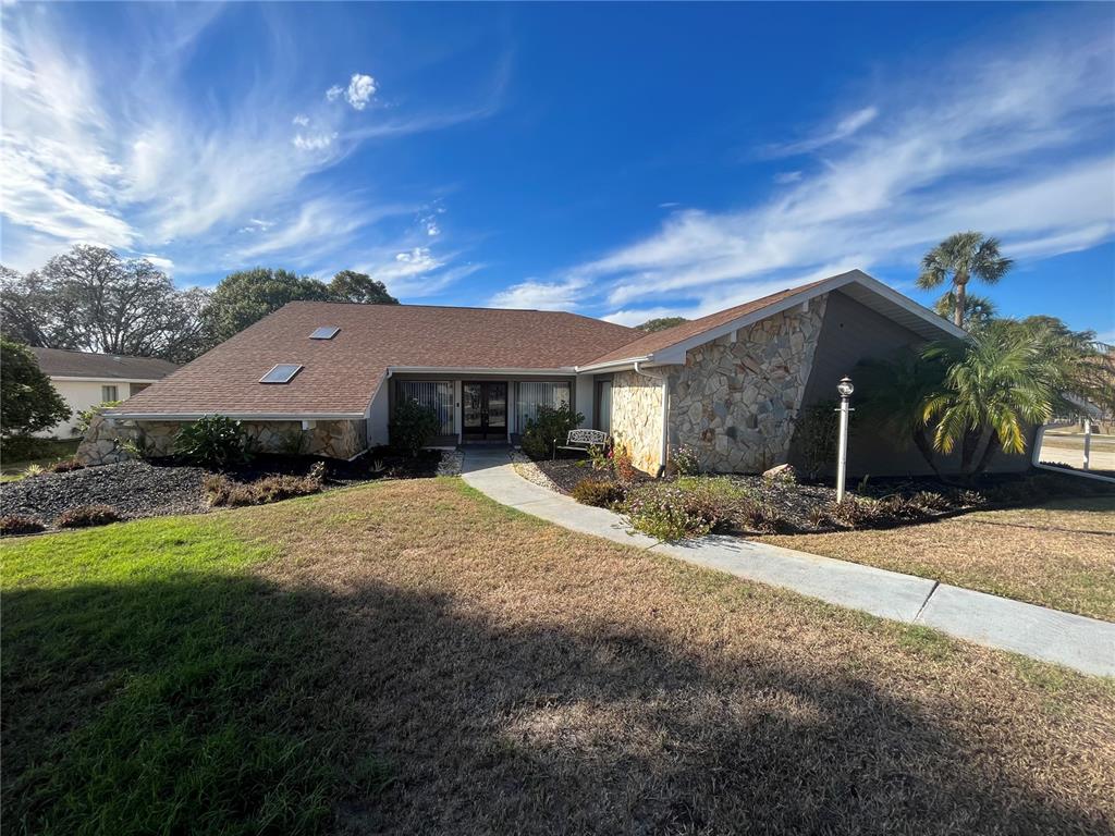 5375 Patricia Place Weeki Wachee, FL 34607 - Photo 3 of 61 a front view of a house with a yard and garage