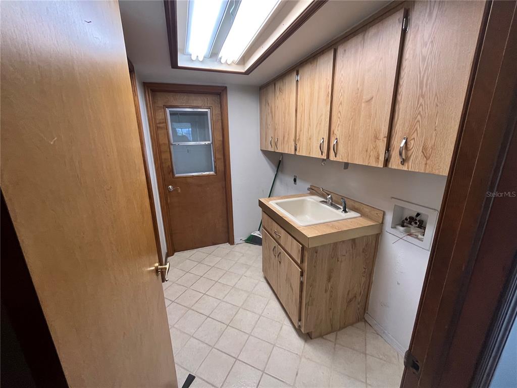5375 Patricia Place Weeki Wachee, FL 34607 - Photo 36 of 61 a utility room with a sink a washer and dryer
