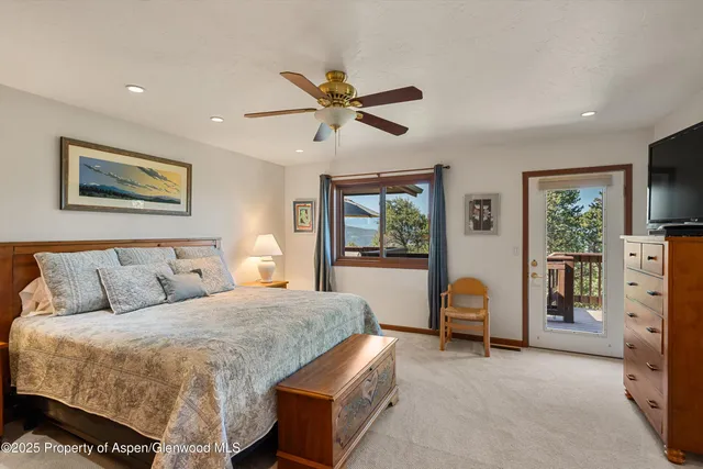 a bathroom with a white tub shower vanity mirror and a sink