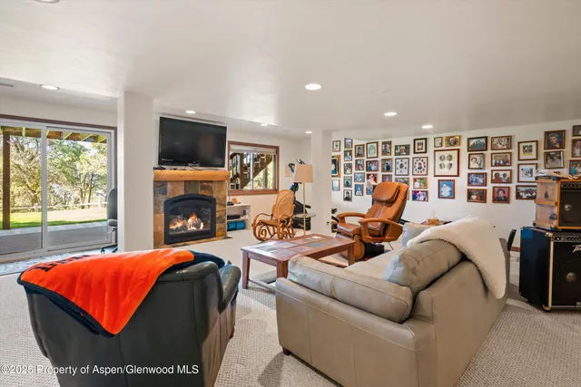 a living room with furniture fireplace and flat screen tv