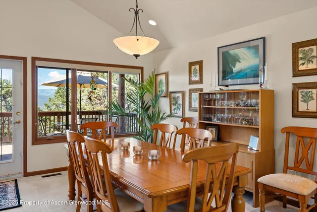 a kitchen with stainless steel appliances kitchen island granite countertop a sink a stove a refrigerator cabinets and chairs