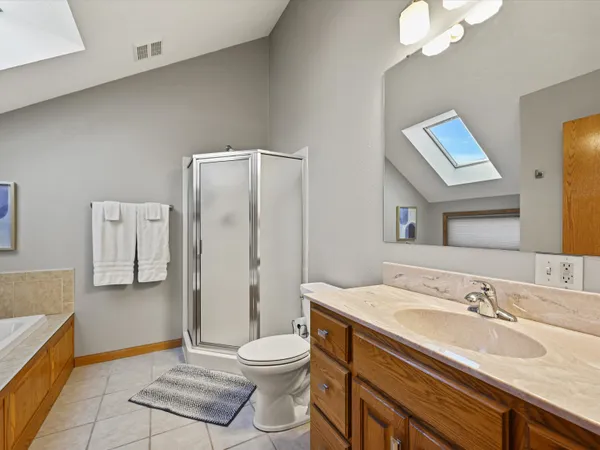 a kitchen with stainless steel appliances granite countertop a stove a sink dishwasher a dining table and chairs with wooden floor