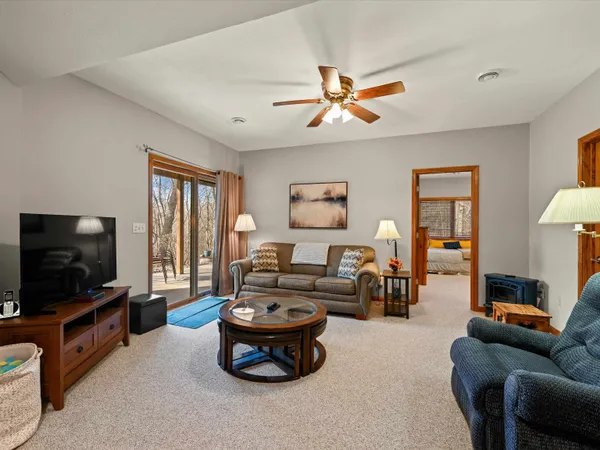 a living room with furniture and a floor to ceiling window