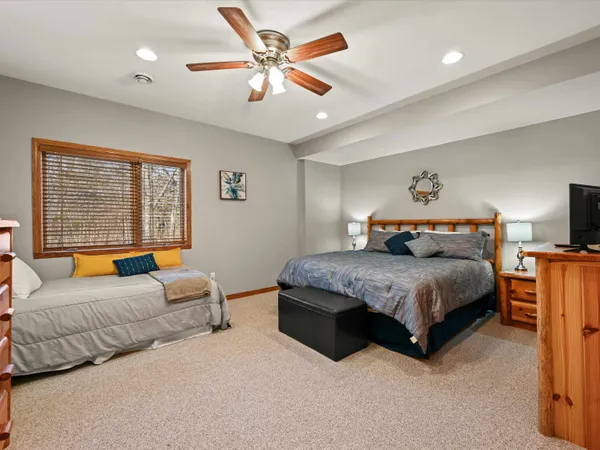 a bedroom with a large bed and a window