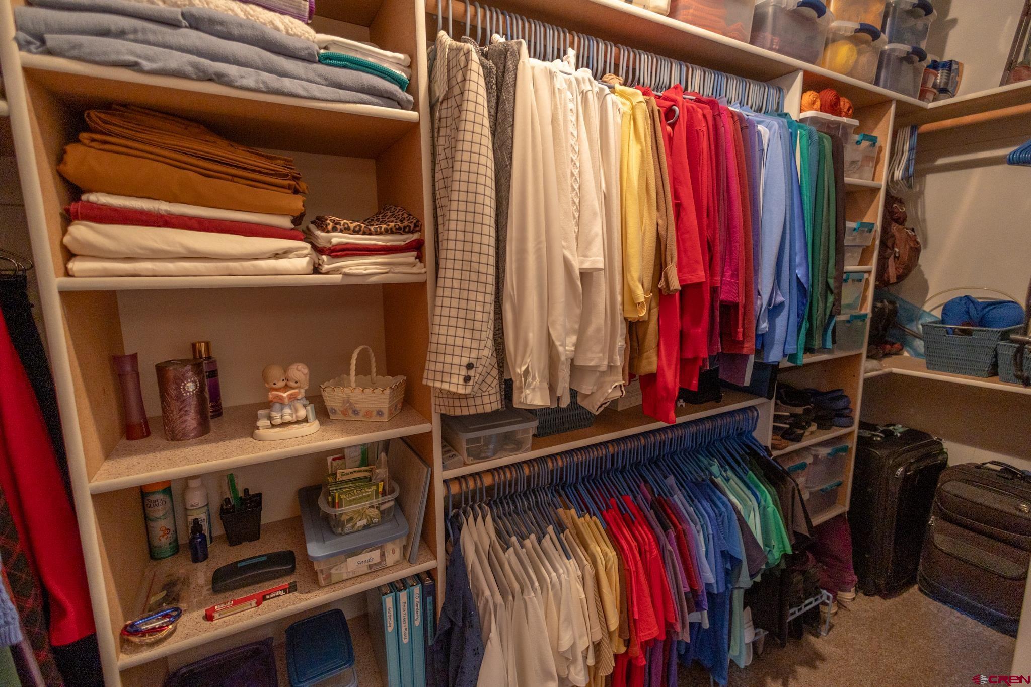 9550 High Mesa Road Olathe, CO 81425 - Photo 12 of 43 a view of walk in closet with clothes and shoes