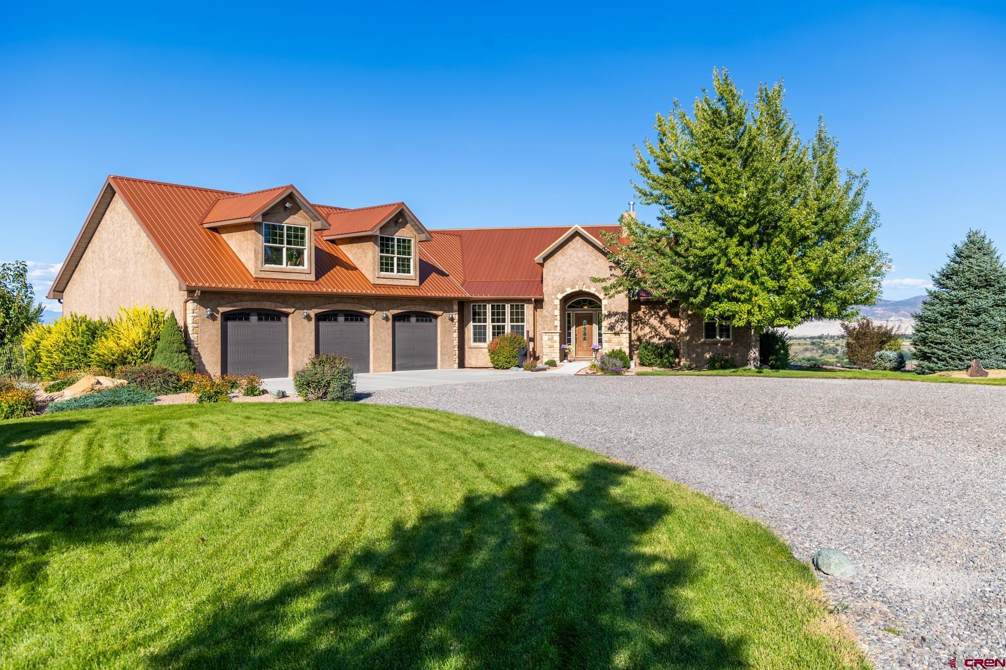 9550 High Mesa Road Olathe, CO 81425 - Photo 3 of 43 a front view of a house with yard and green space