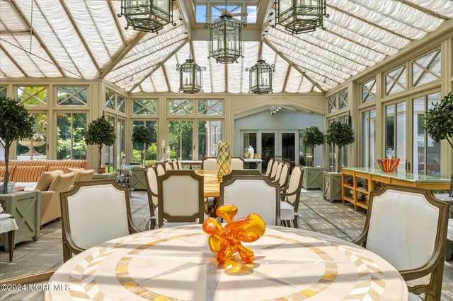 a view of a patio with dining table and chairs