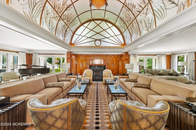 a living room with furniture and a chandelier