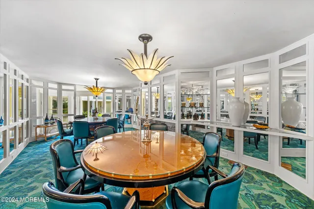 a dining room with furniture and a potted plant