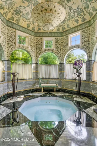 a view of a swimming pool with a patio and a yard