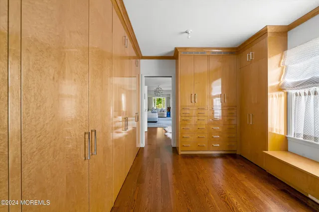 a view of hallway with livingroom and wooden floor