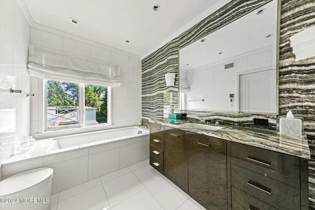 a bath room with a sink and a large window
