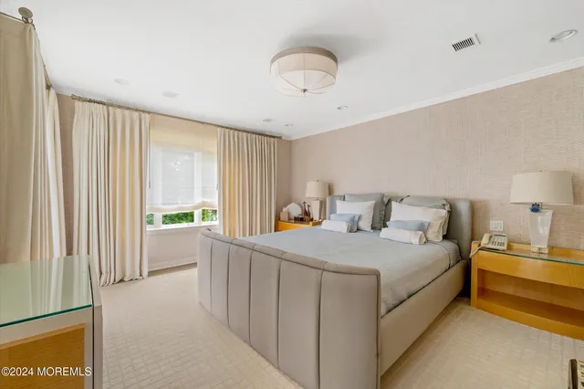 a bedroom with a bed and a large window