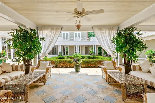 a view of a house with backyard porch and sitting area