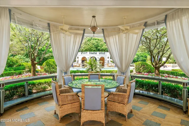 a dining room with furniture water view and balcony