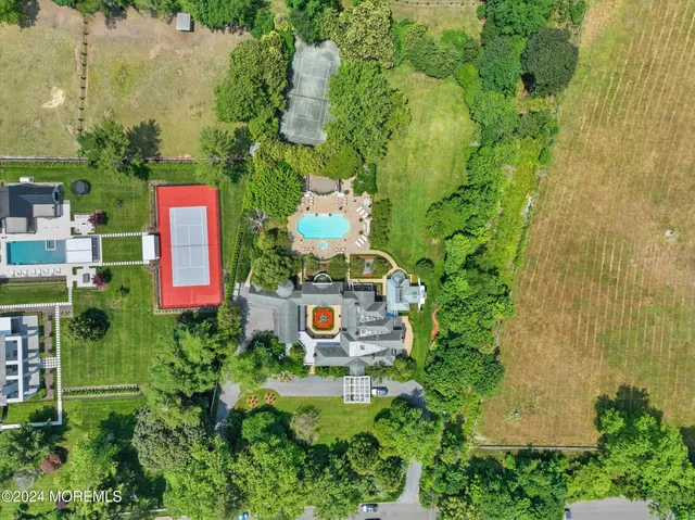 an aerial view of a house with swimming pool and garden