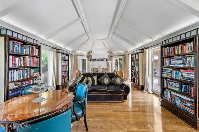 a living room with furniture and a book shelf