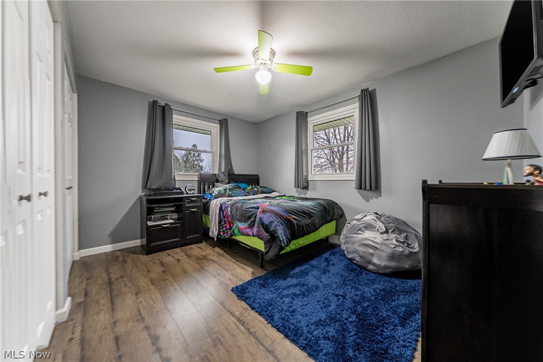 7791 Ridge Road Parma, OH 44129 - Photo 19 of 41 Bedroom with dark wood-type flooring, a ceiling fan, and a closet
