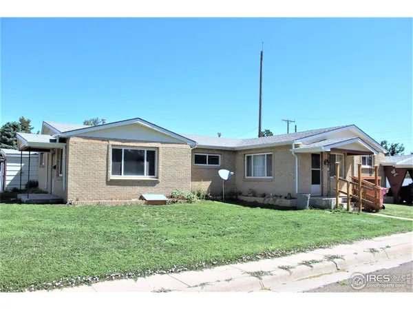 a front view of house with a garden