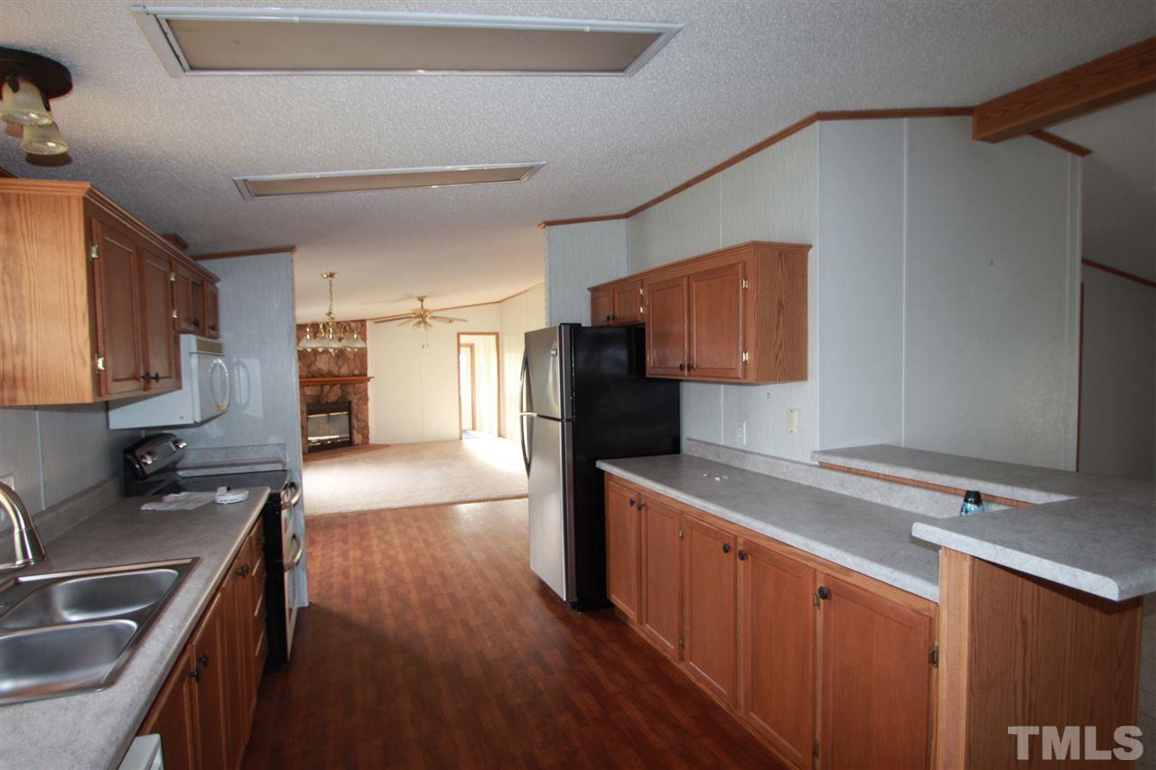 545 Duke Drive Rougemont, NC 27572 - Photo 5 of 14 a kitchen with stainless steel appliances granite countertop a sink stove and refrigerator