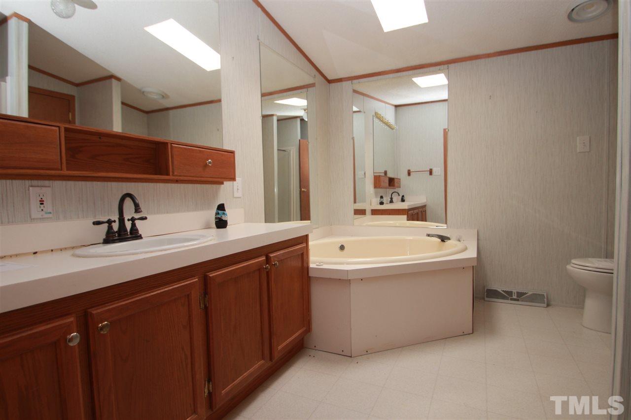 545 Duke Drive Rougemont, NC 27572 - Photo 8 of 14 a bathroom with a tub sink mirror and toilet