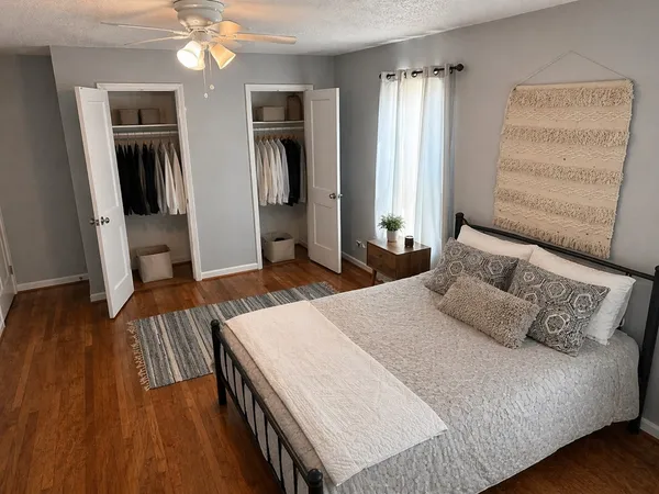a bedroom with a bed and wooden floor