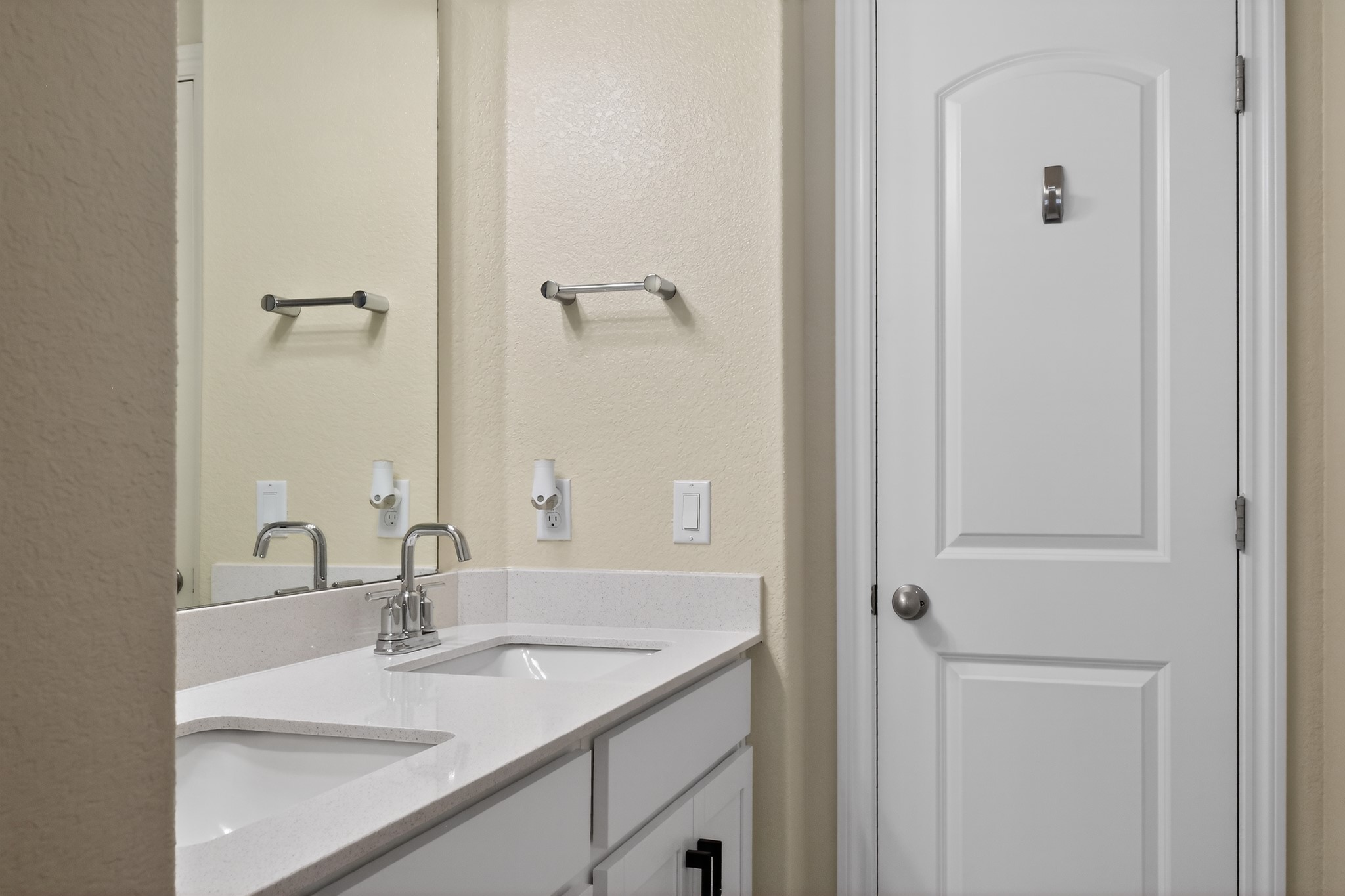 114 Bosco Road Hutto, TX 78634 - Photo 23 of 39 Double vanities with sleek white counters offer practicality and elegance in this well-appointed bathroom.