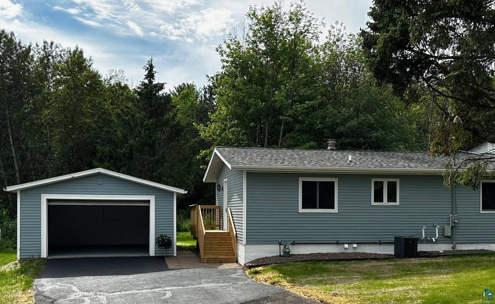 4207 Trinity Road Duluth, MN 55811 - Photo 2 of 40 View of front of property featuring a garage, an outdoor structure, and central AC unit