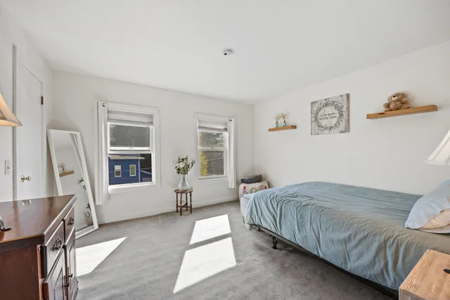 a bedroom with a bed couch and a window