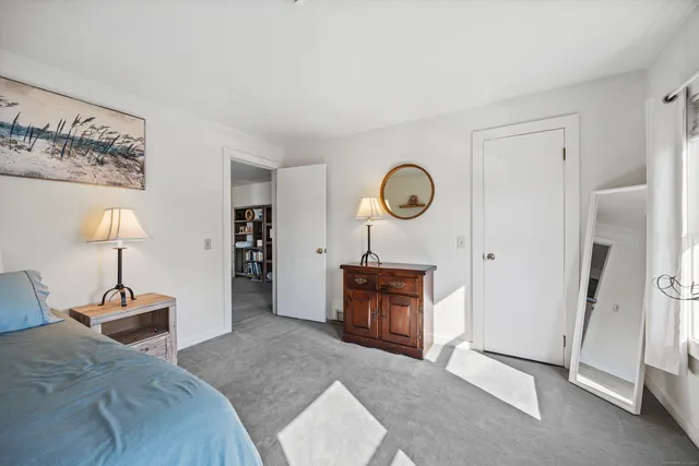 a bed room with a bed and a lamp