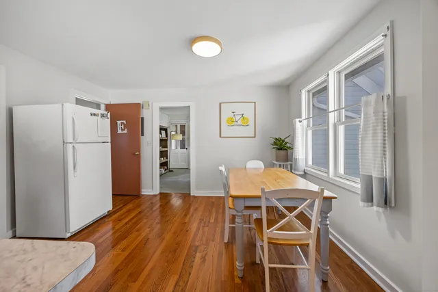 a view of a dining room with furniture and a wooden floor