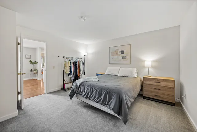 a spacious bedroom with a bed and a walk in closet