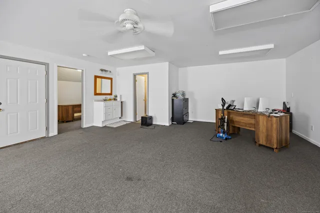 a view of empty room with furniture and ceiling fan