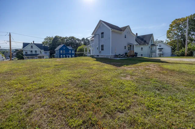 a view of a house with a yard and garage