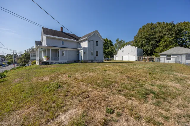 a large house with a big yard and large trees