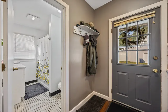 a view of a hallway with wooden floor and closet