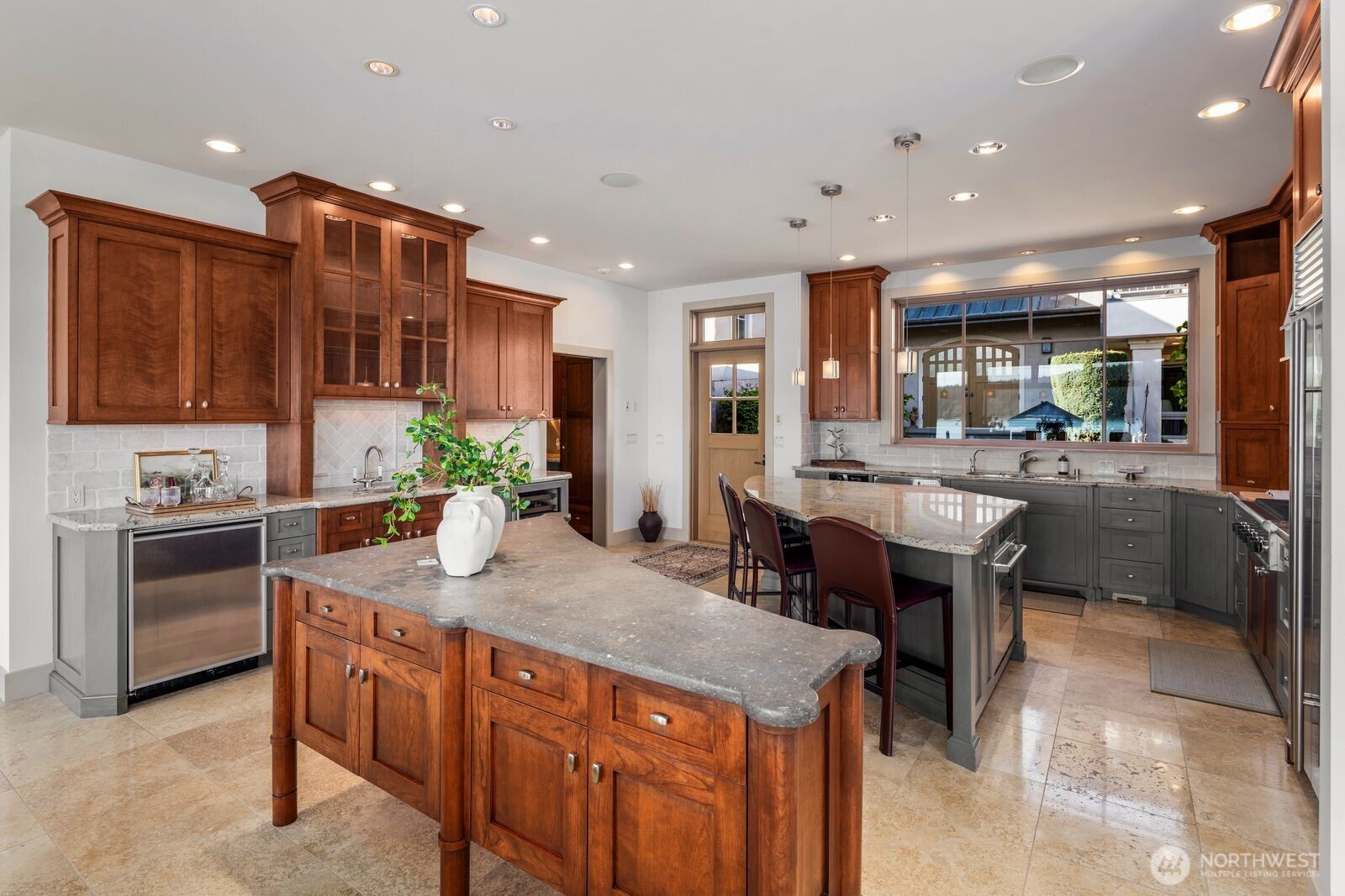 15283 Gibralter Road Anacortes, WA 98221 - Photo 13 of 40 a kitchen with kitchen island granite countertop a sink and a refrigerator