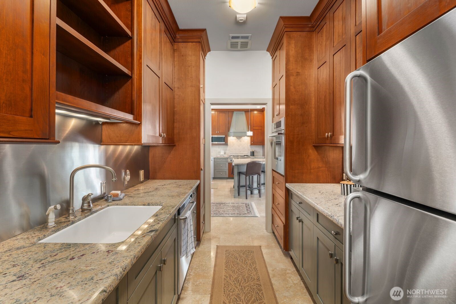 15283 Gibralter Road Anacortes, WA 98221 - Photo 15 of 40 a kitchen with stainless steel appliances granite countertop a sink and a refrigerator