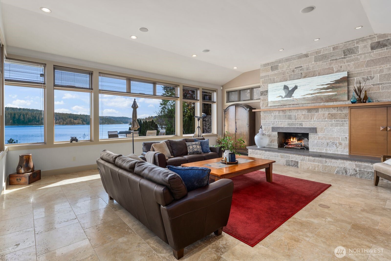 15283 Gibralter Road Anacortes, WA 98221 - Photo 20 of 40 a living room with furniture large window and a fireplace
