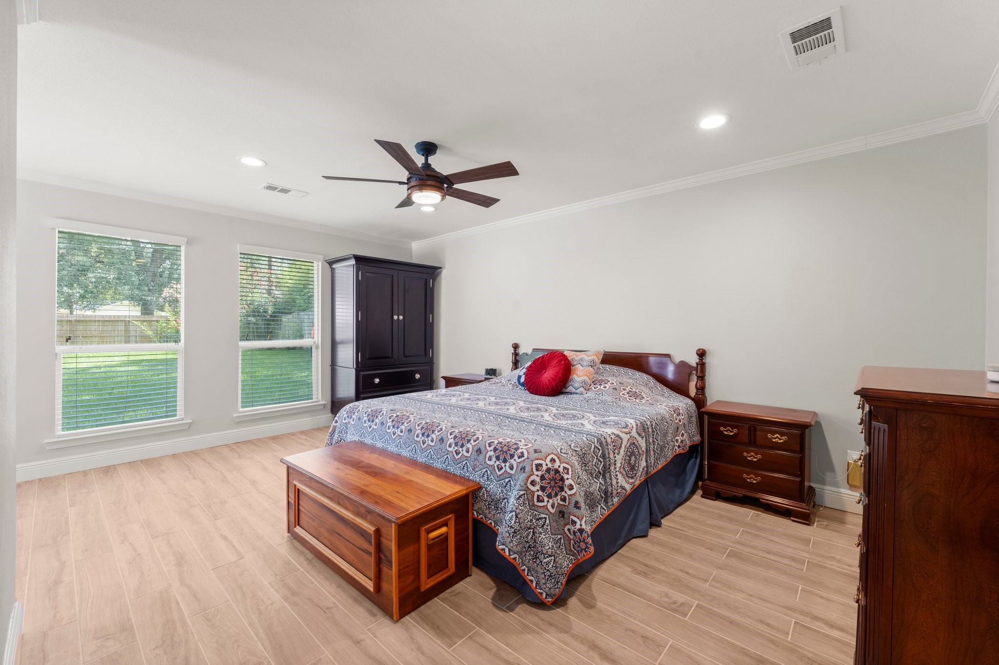 6030 Craigway Road Spring, TX 77389 - Photo 20 of 45 This inviting bedroom features two windows overlooking the backyard. The room has a ceiling fan and recessed lighting, creating a comfortable, airy atmosphere.